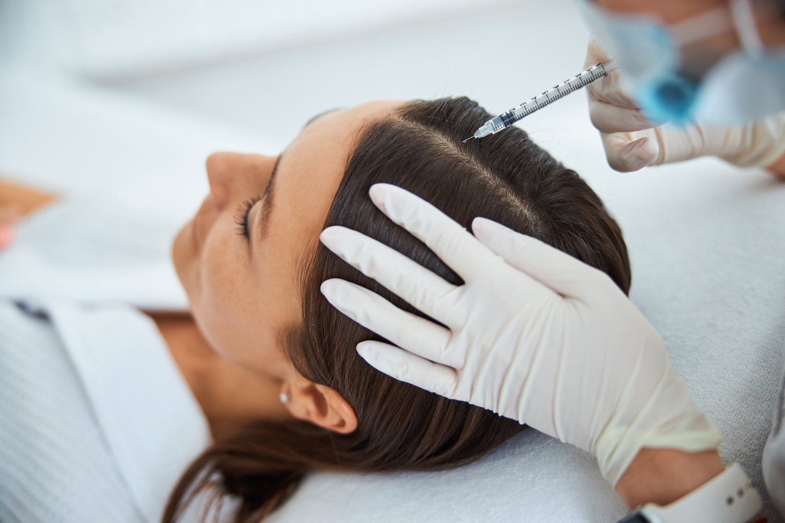 Young woman getting the serum scalp injection